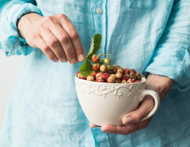 Midsection of man holding fruit