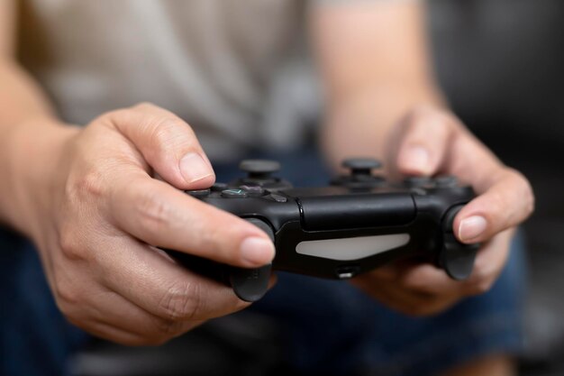 Midsection of man holding game console