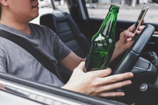 Midsection of man holding glass bottle