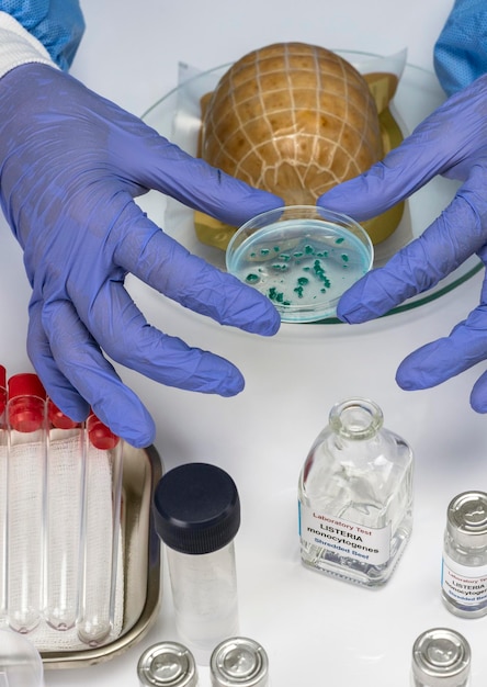 Photo midsection of man holding glass bottles on table