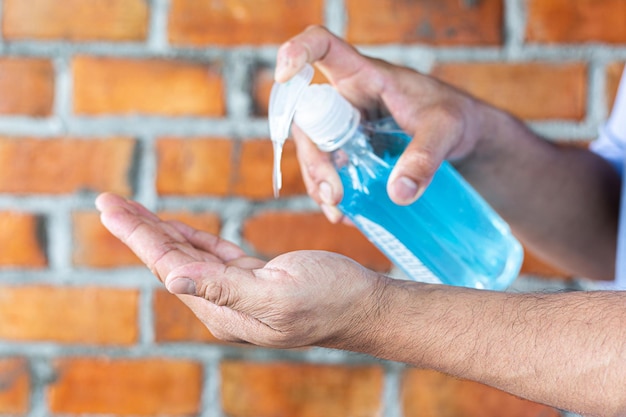 Midsection of man holding hands against wall