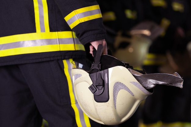 Midsection of man holding hardhat
