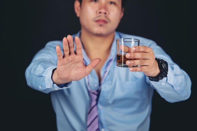 Photo midsection of man holding ice cream against black background