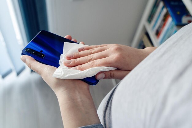 midsection of man holding mobile phone