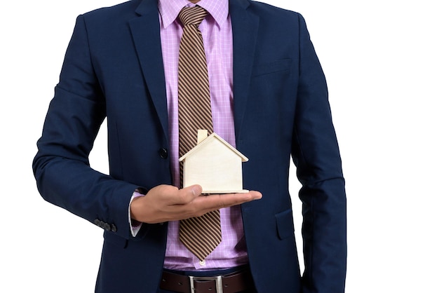 Photo midsection of man holding model home against white background