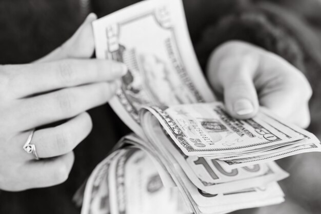 midsection of man holding paper currency