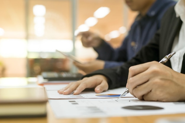 Midsection of man holding paper on table