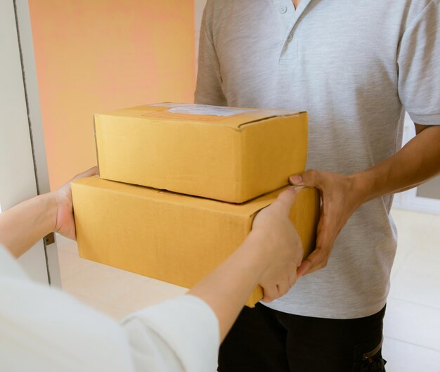 Midsection of man holding paper while standing against wall