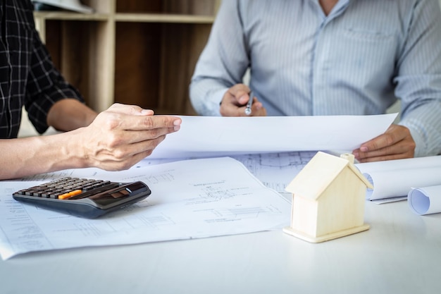 midsection of man holding paper with knife on table