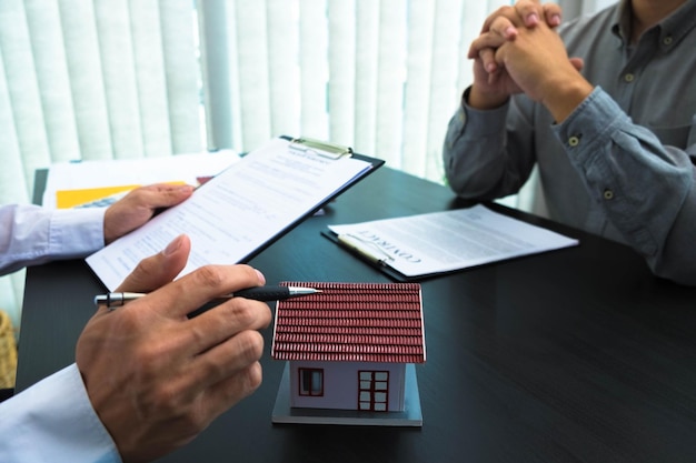 Photo midsection of man holding paper with text on table