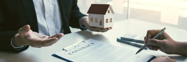 Midsection of man holding paper with text on table