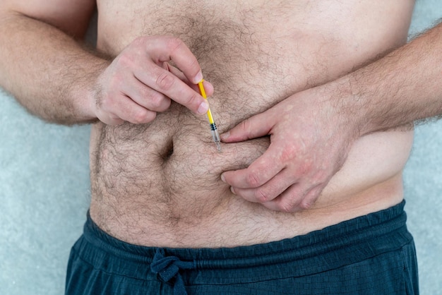 Midsection of man holding tape measure