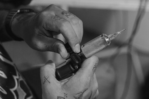 Photo midsection of man holding tattoo machine