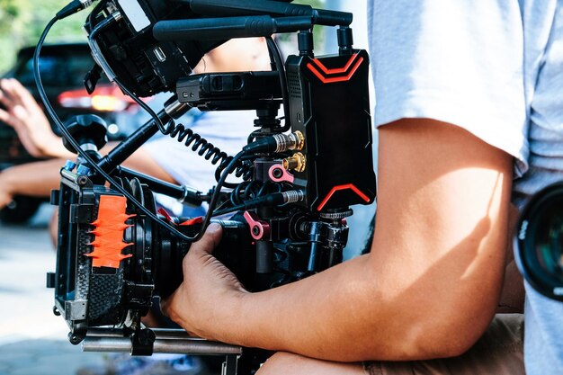 Photo midsection of man holding television camera