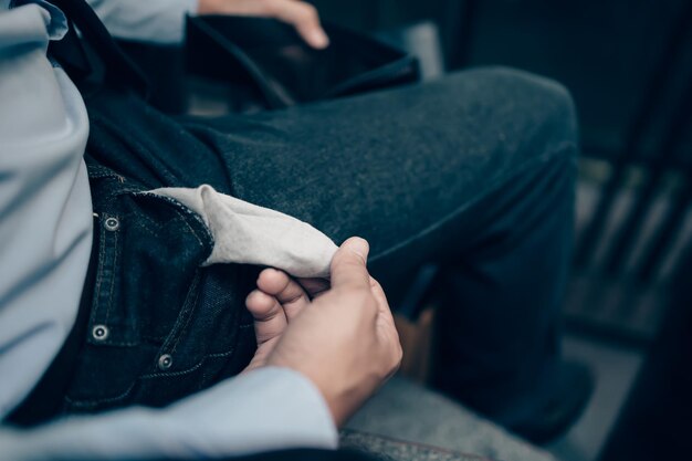 Photo midsection of man holding while sitting at home