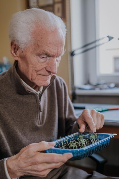 Photo midsection of man holding while sitting on table