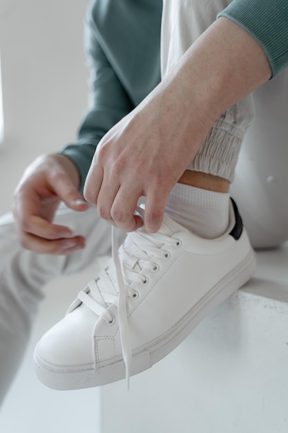 Midsection of man holding white while sitting on floor