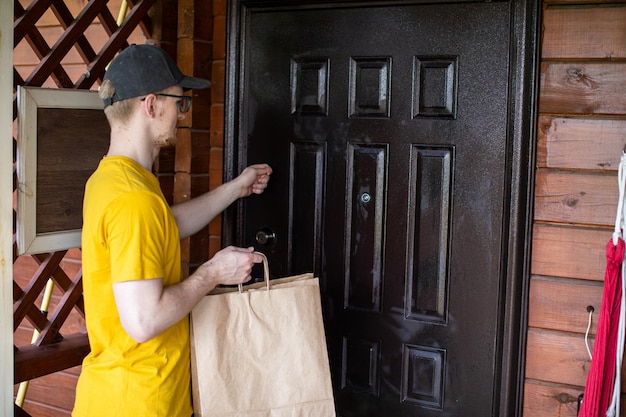 Photo midsection of man holding yellow while standing by door
