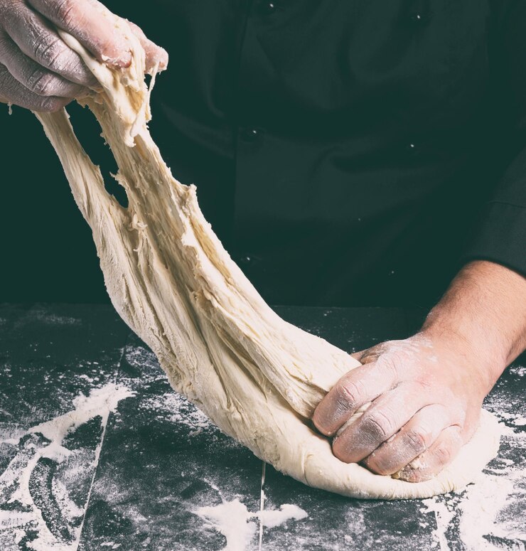 Photo midsection of man kneading dough