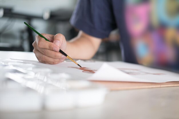 Photo midsection of man painting on table