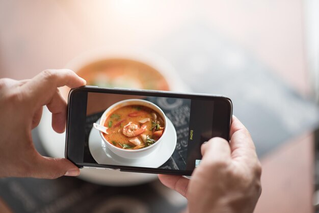 Photo midsection of man photographing with mobile phone