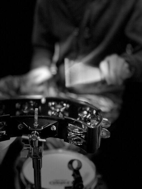 Midsection of man playing drum