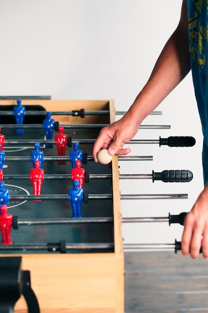 Photo midsection of man playing foosball at home