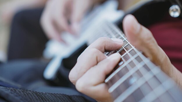 Photo midsection of man playing guitar outdoors