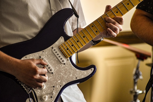 Foto sezione centrale di un uomo che suona la chitarra