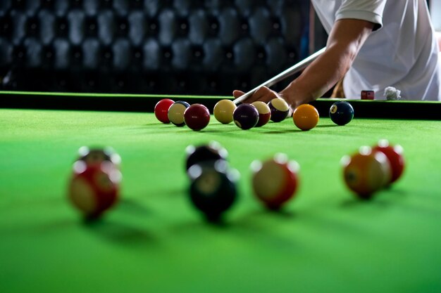 Midsection of man playing pool on table