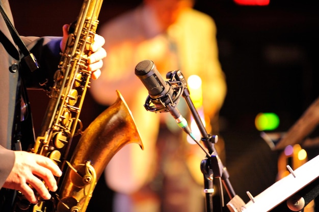 Photo midsection of man playing saxophone at music concert