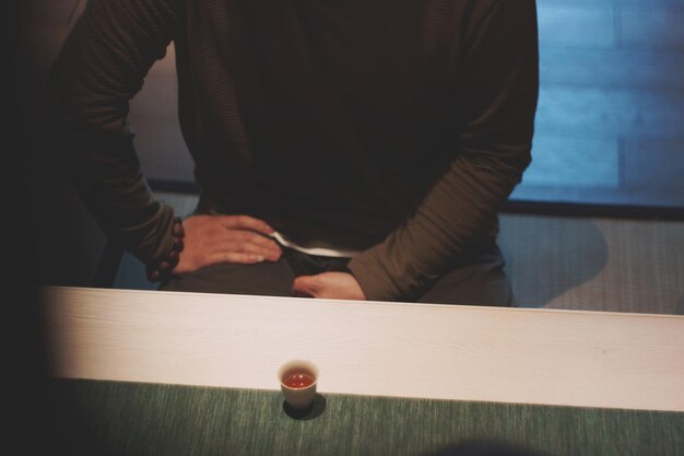 midsection of man playing with ball on table