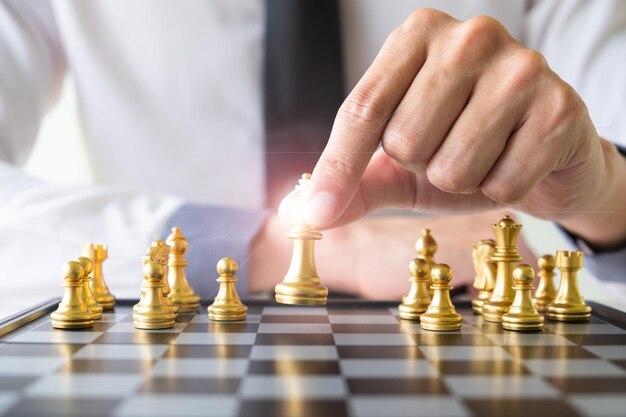 Midsection of man playing with chess