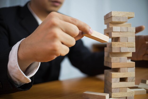 Midsection of man playing with toy blocks on table