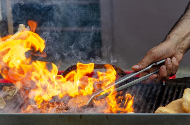 Photo midsection of man preparing food on barbecue grill