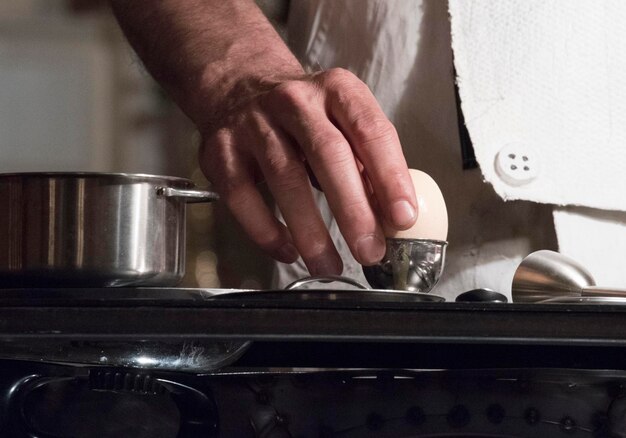 Midsection of man preparing food in kitchen