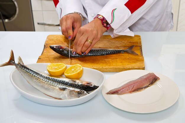 Midsection of man preparing food in plate on table