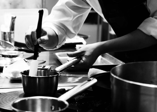 Midsection of man preparing food in restaurant