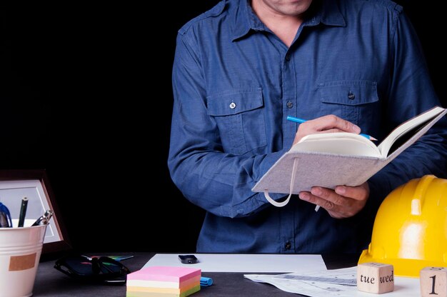 Midsection of man reading book on table