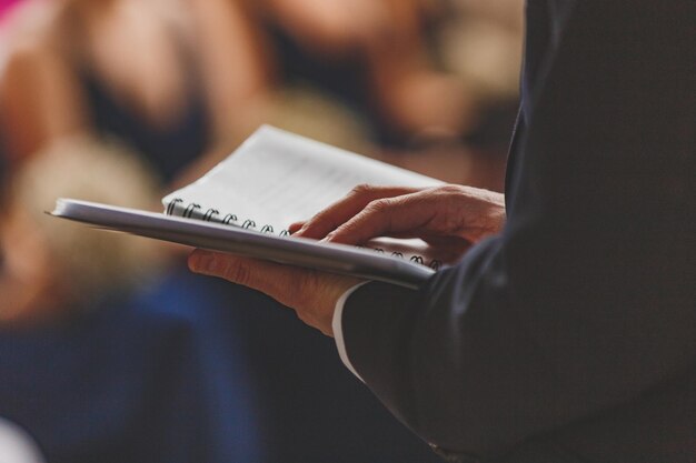 Photo midsection of man reading books