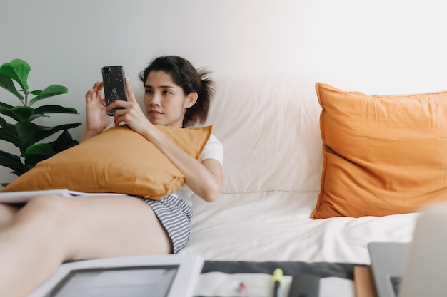 Midsection of man relaxing on bed at home