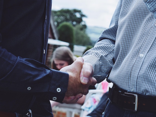 midsection of man shaking hands