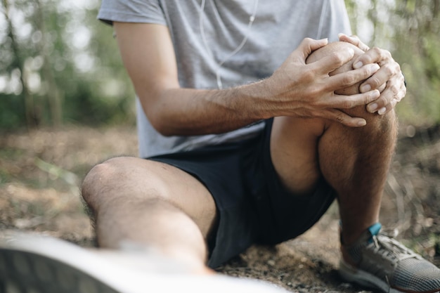 Midsection of man sitting outdoors