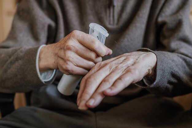 Photo midsection of man spraying sanitizer