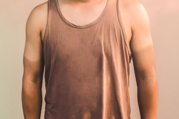 Midsection of man standing against beige background