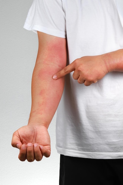 midsection of man standing against white wall