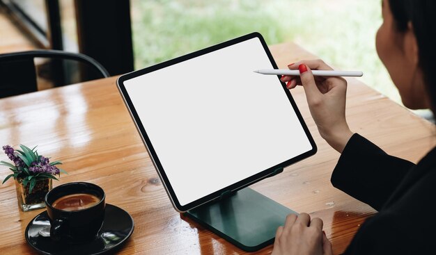 Photo midsection of man using digital tablet on table