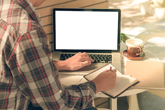 Midsection of man using laptop at cafe