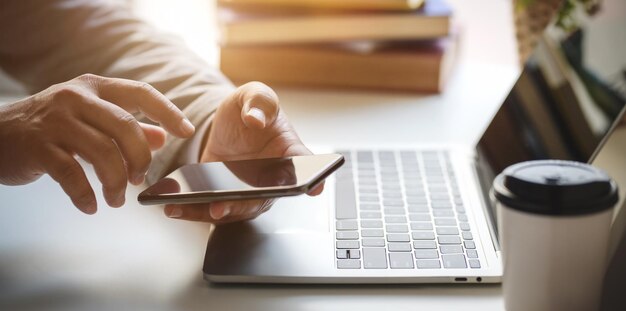 Midsection of man using laptop on table