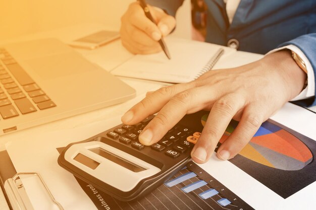 Photo midsection of man using laptop on table